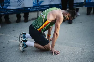 Vận động viên kiệt sức quỳ xuống sau khi hoàn thành marathon